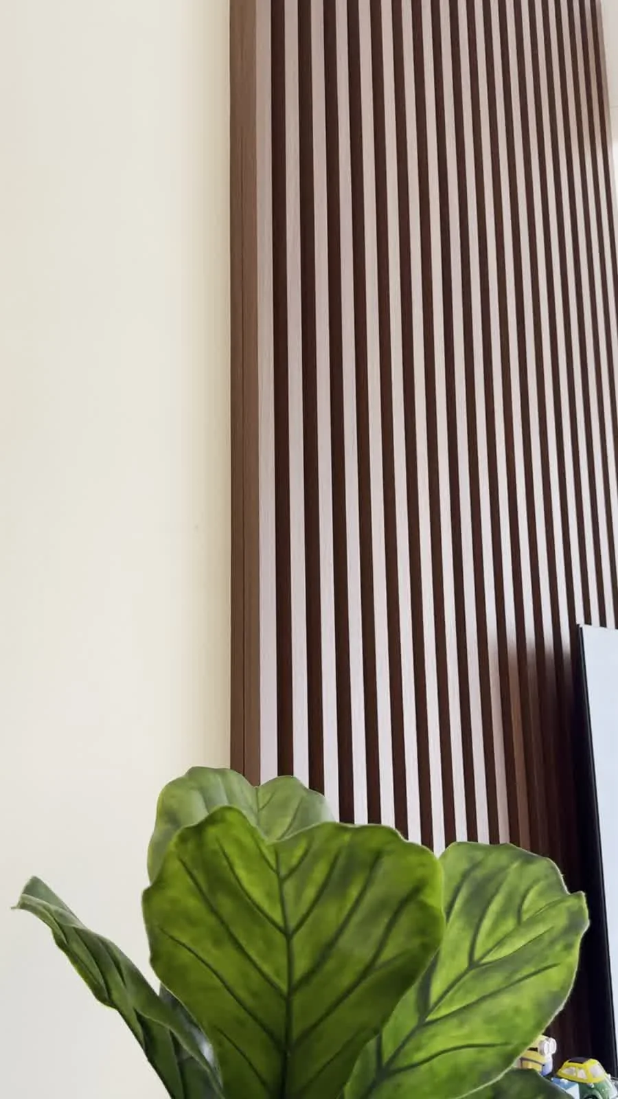 Walnut wall detail at Molek Regency, from the project video
